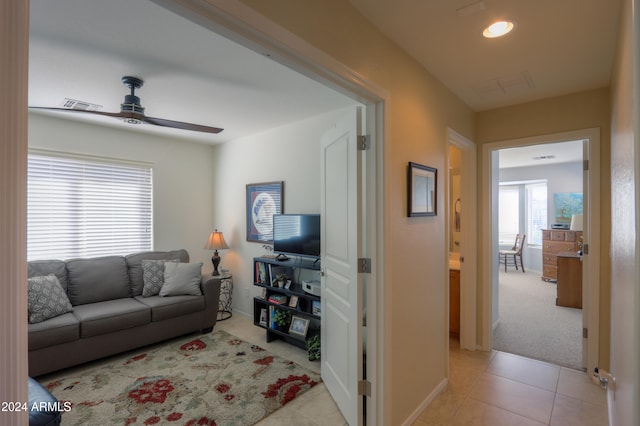 living room with light carpet and ceiling fan