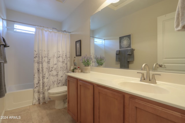 full bathroom featuring tile patterned floors, vanity, toilet, and shower / bath combo with shower curtain