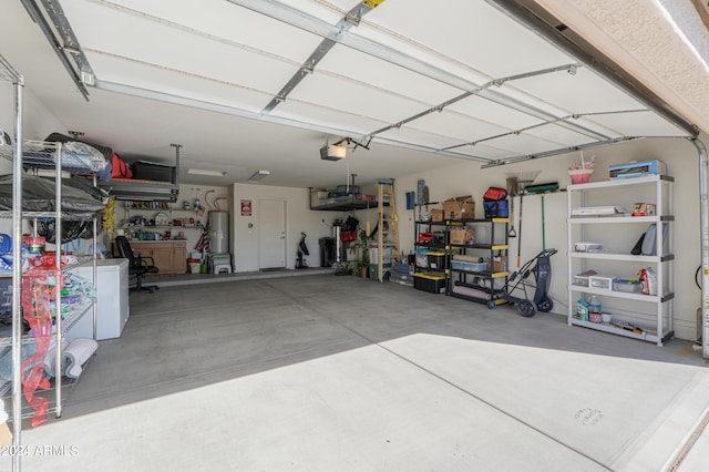 garage with a garage door opener and water heater