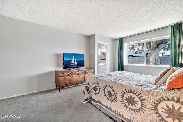 bedroom featuring baseboards, a textured ceiling, ensuite bath, and carpet flooring