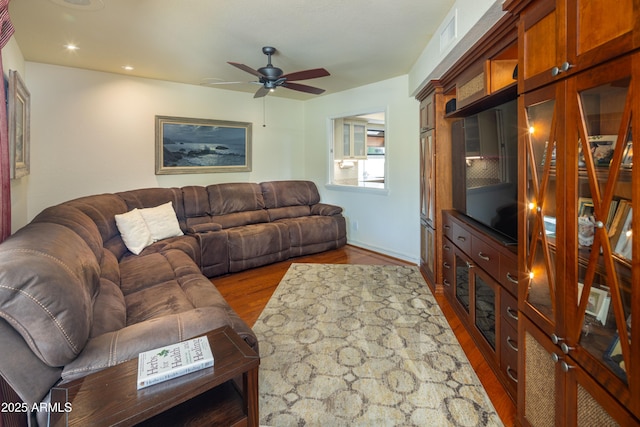 living room with a ceiling fan, recessed lighting, visible vents, and wood finished floors