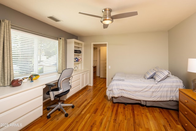 bedroom with light wood-type flooring, visible vents, and ceiling fan