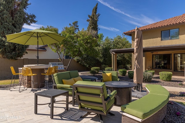 view of patio featuring an outdoor hangout area, fence, outdoor dry bar, and area for grilling