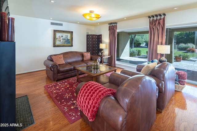 living area with visible vents, wood finished floors, and recessed lighting