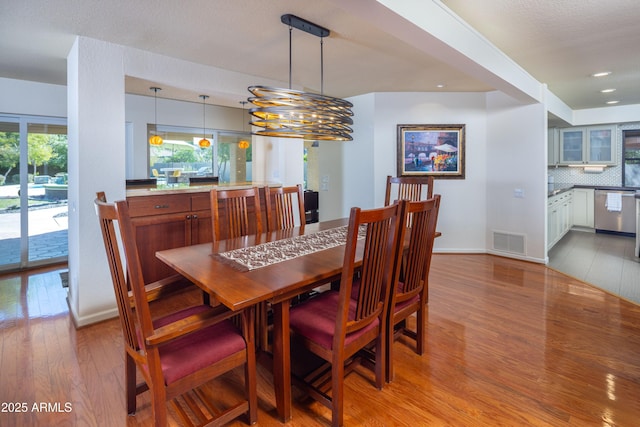 dining room featuring recessed lighting, visible vents, baseboards, and wood finished floors