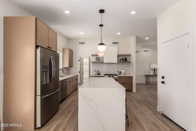 kitchen featuring modern cabinets, visible vents, appliances with stainless steel finishes, and open shelves