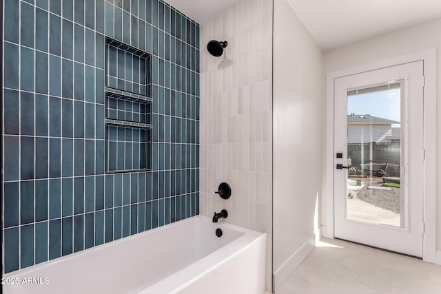 bathroom with baseboards and shower / washtub combination