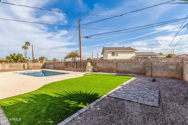 view of yard featuring a fenced backyard, a fenced in pool, and a patio area