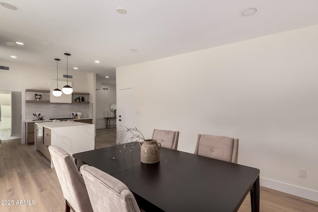 dining area featuring recessed lighting, baseboards, visible vents, and light wood-type flooring
