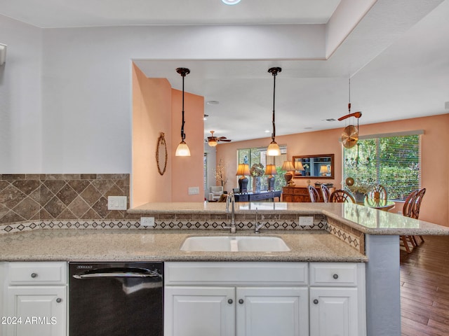 kitchen with white cabinets, black dishwasher, hanging light fixtures, and hardwood / wood-style flooring