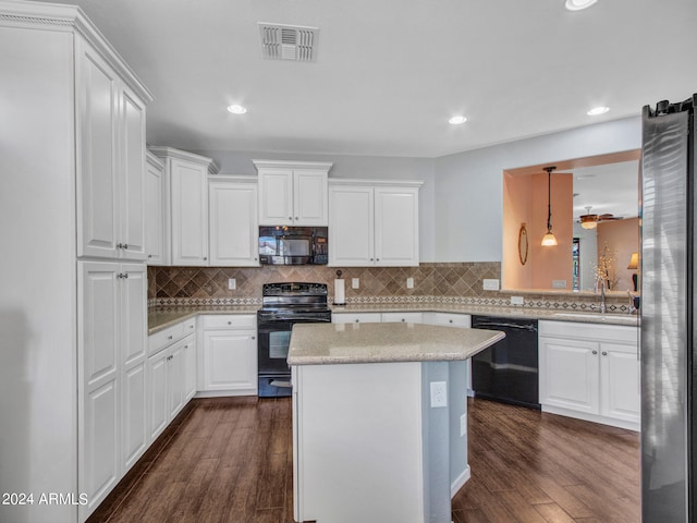 kitchen featuring white cabinetry, black appliances, a center island, decorative light fixtures, and dark hardwood / wood-style floors