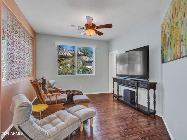 living area with ceiling fan and dark hardwood / wood-style floors