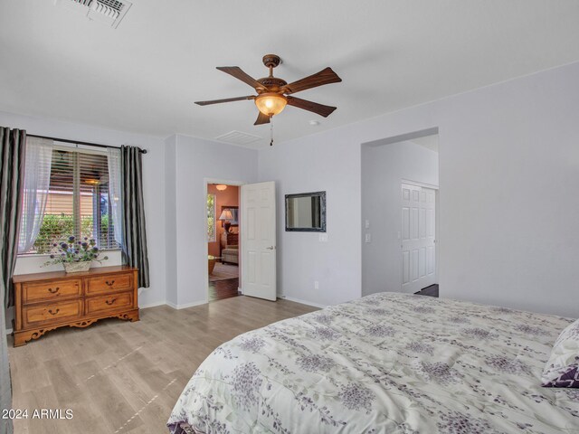 bedroom with light hardwood / wood-style flooring and ceiling fan