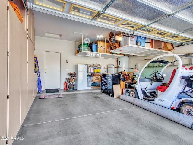 garage featuring a garage door opener and white fridge