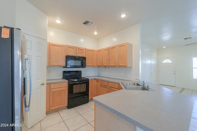 kitchen featuring black appliances, light tile patterned floors, light brown cabinets, sink, and kitchen peninsula