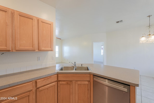 kitchen with an inviting chandelier, kitchen peninsula, light tile patterned floors, sink, and stainless steel dishwasher