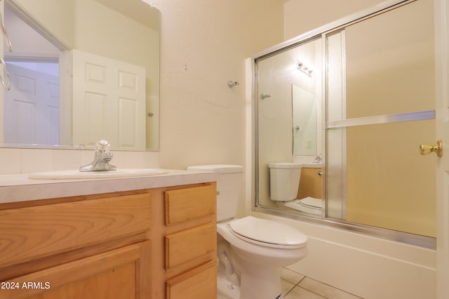 full bathroom with toilet, shower / bath combination with glass door, tile patterned floors, and vanity