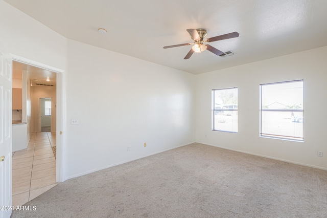 carpeted empty room featuring ceiling fan