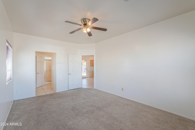 carpeted spare room featuring ceiling fan