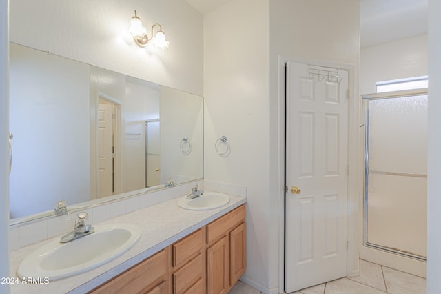 bathroom featuring vanity, an enclosed shower, and tile patterned floors