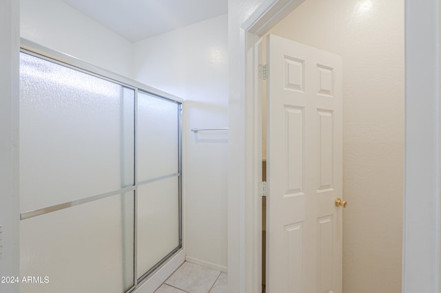 bathroom featuring tile patterned floors and a shower with door