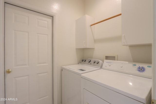 laundry room featuring cabinets and separate washer and dryer