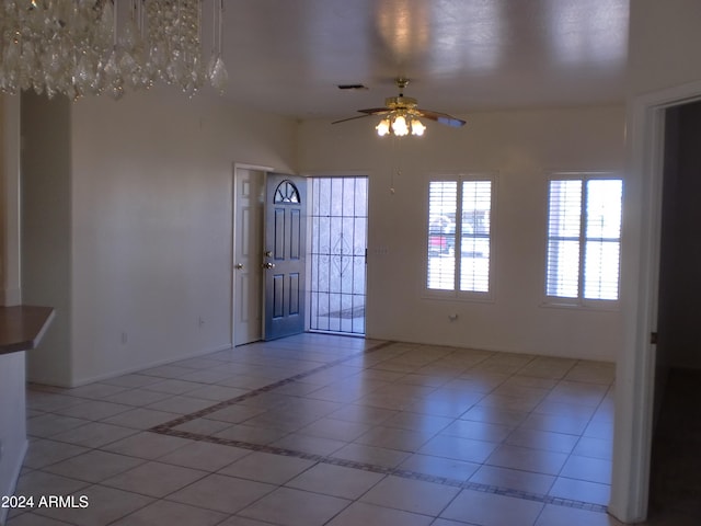 tiled empty room with ceiling fan