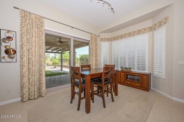 tiled dining space featuring ceiling fan