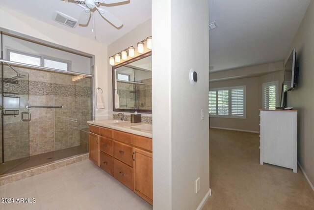 bathroom featuring ceiling fan, an enclosed shower, double sink vanity, and tile patterned floors