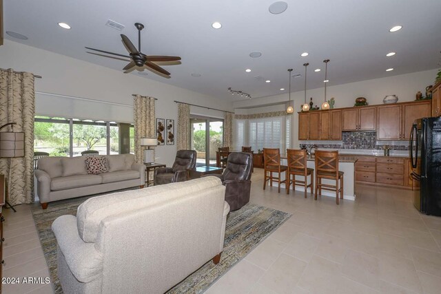 tiled living room featuring ceiling fan