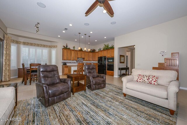 tiled living room with ceiling fan