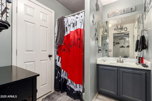 bathroom with a shower with shower curtain, visible vents, and vanity