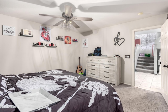 bedroom with a ceiling fan and light carpet