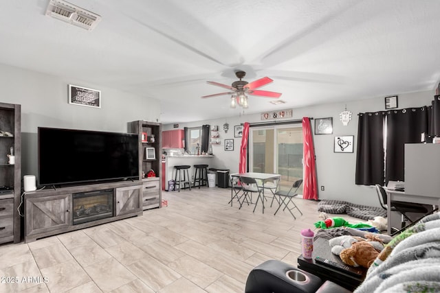 living room with visible vents and ceiling fan