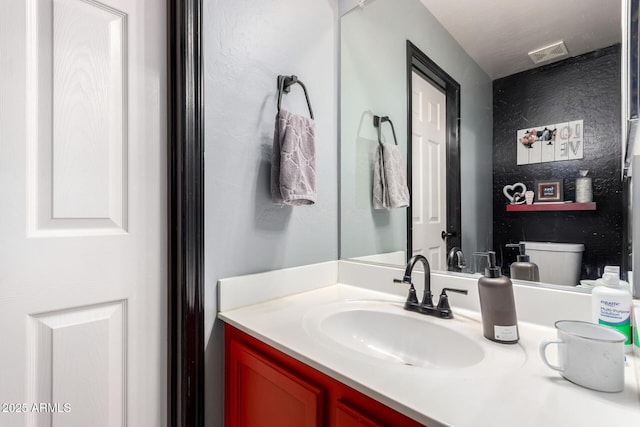 bathroom with visible vents and vanity