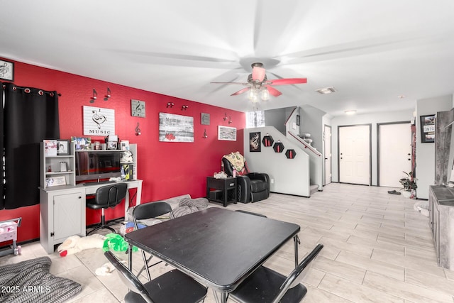 playroom featuring visible vents, an accent wall, and a ceiling fan