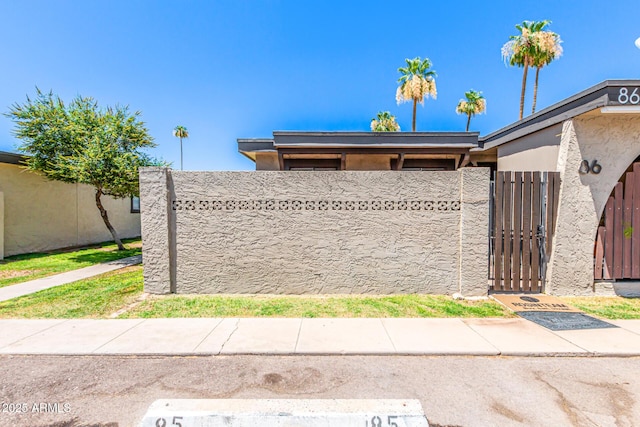 830 S Dobson Rd Unit 86, Mesa, AZ 85202 - view of property exterior featuring a gate and stucco siding