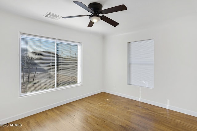 spare room with ceiling fan and wood-type flooring