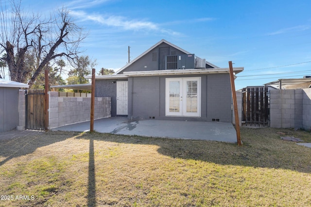 rear view of property with french doors, a lawn, and a patio area