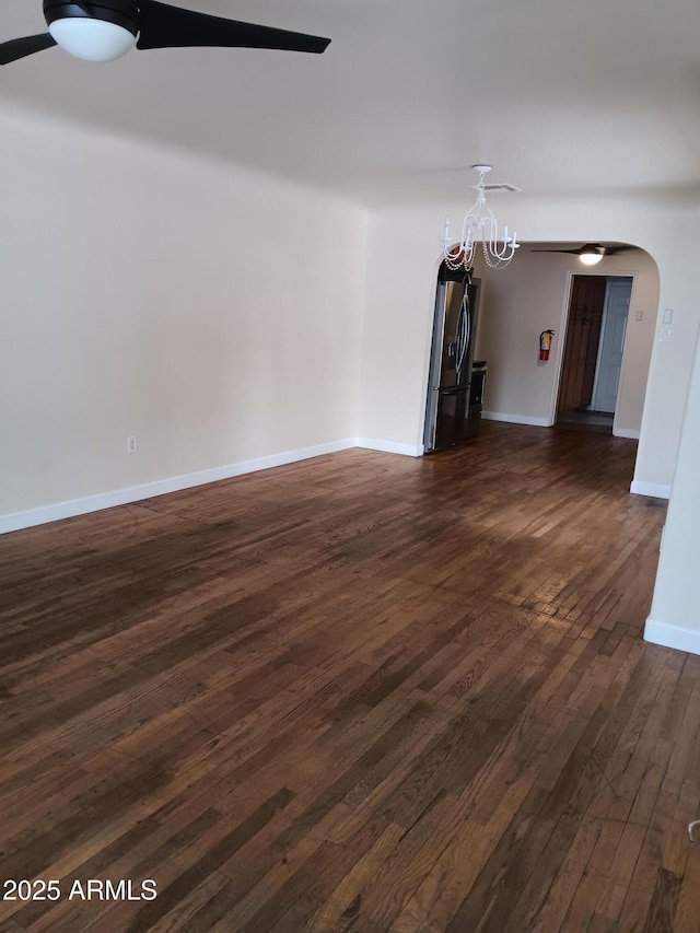 empty room with dark hardwood / wood-style flooring and ceiling fan