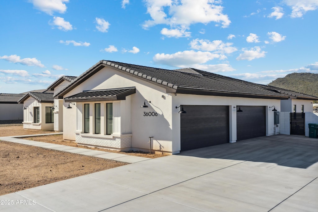 1620 W Butte Canyon Rd, Phoenix, AZ 85086 - view of front of property with driveway, a garage, brick siding, and stucco siding