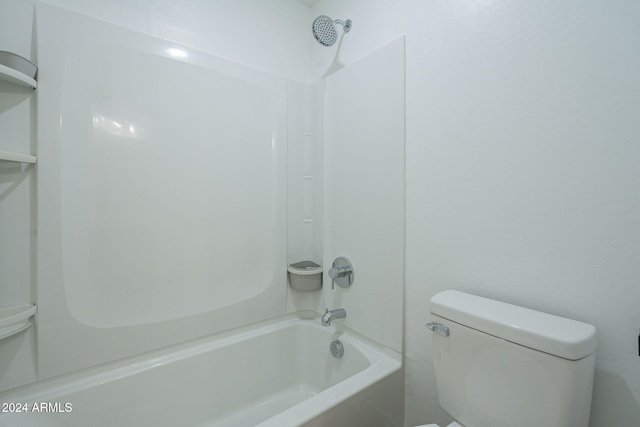 bathroom with shower / washtub combination and toilet