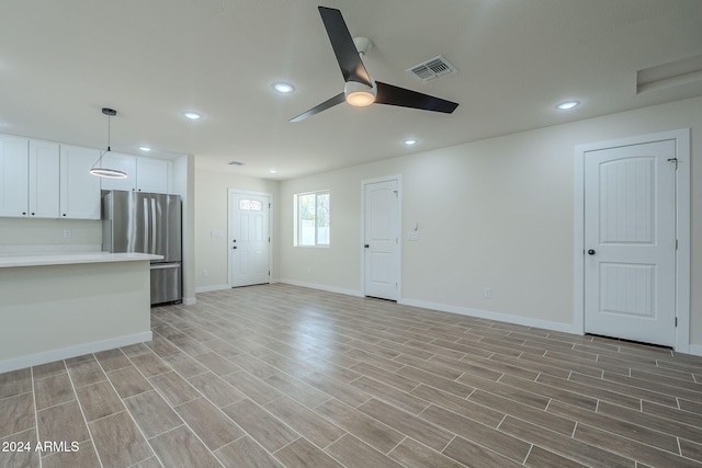 unfurnished living room featuring light hardwood / wood-style flooring and ceiling fan