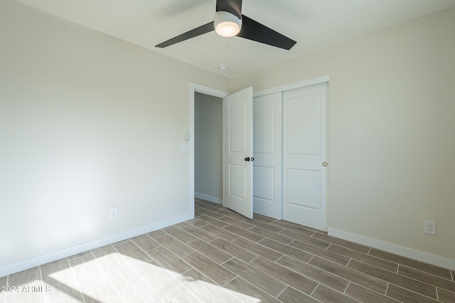 unfurnished bedroom with ceiling fan and a closet