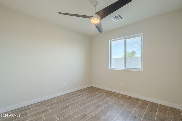 empty room with ceiling fan and light hardwood / wood-style floors