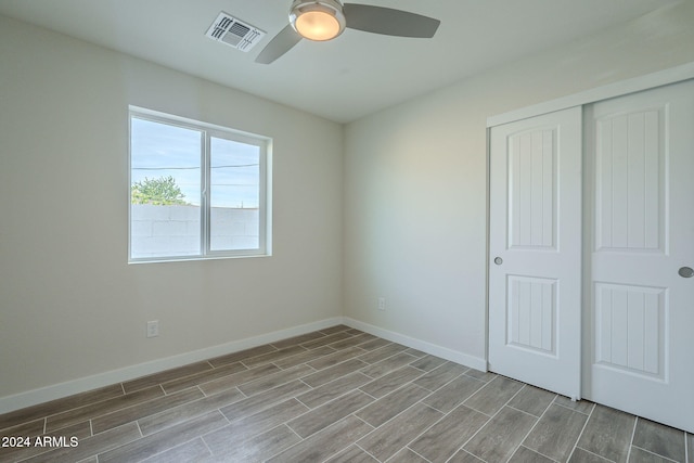 unfurnished bedroom featuring a closet and ceiling fan