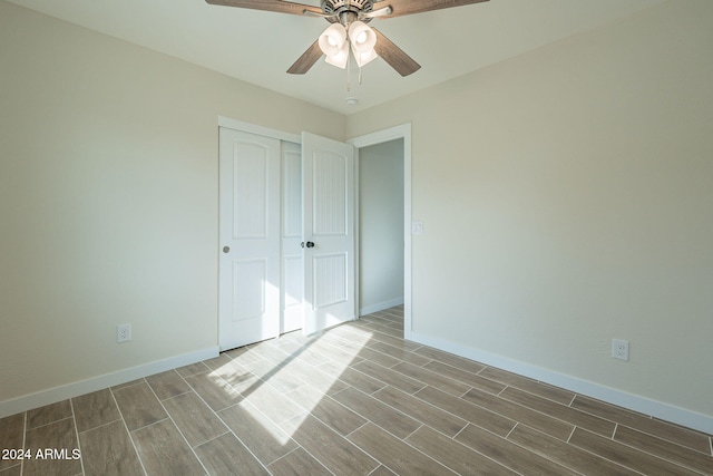 unfurnished bedroom featuring a closet and ceiling fan