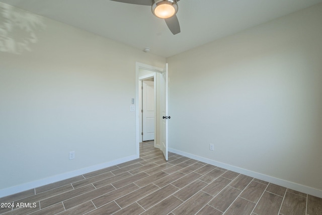 spare room with ceiling fan and light wood-type flooring