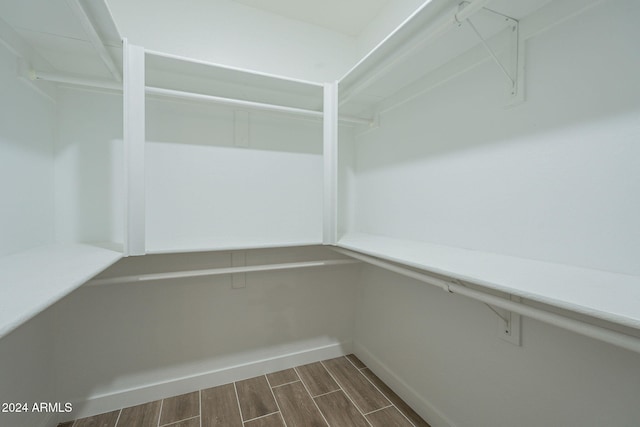 spacious closet featuring dark wood-type flooring