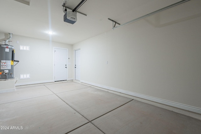 garage featuring water heater and a garage door opener